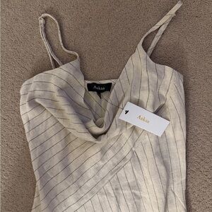 Aakaa brand women’s beige dress with black pin stripes. Mid length. Size small.